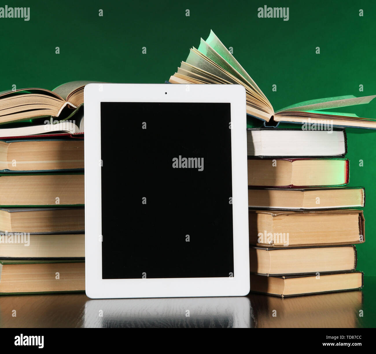 Tablet and books on bright background Stock Photo