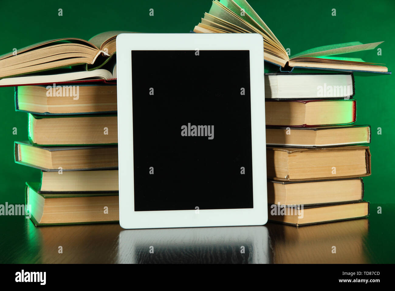 Tablet and books on bright background Stock Photo