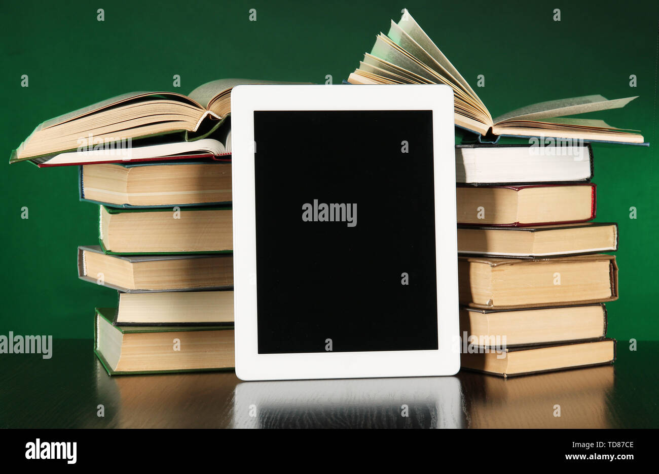 Tablet and books on bright background Stock Photo