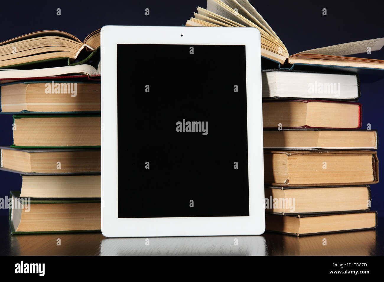 Tablet and books on bright background Stock Photo
