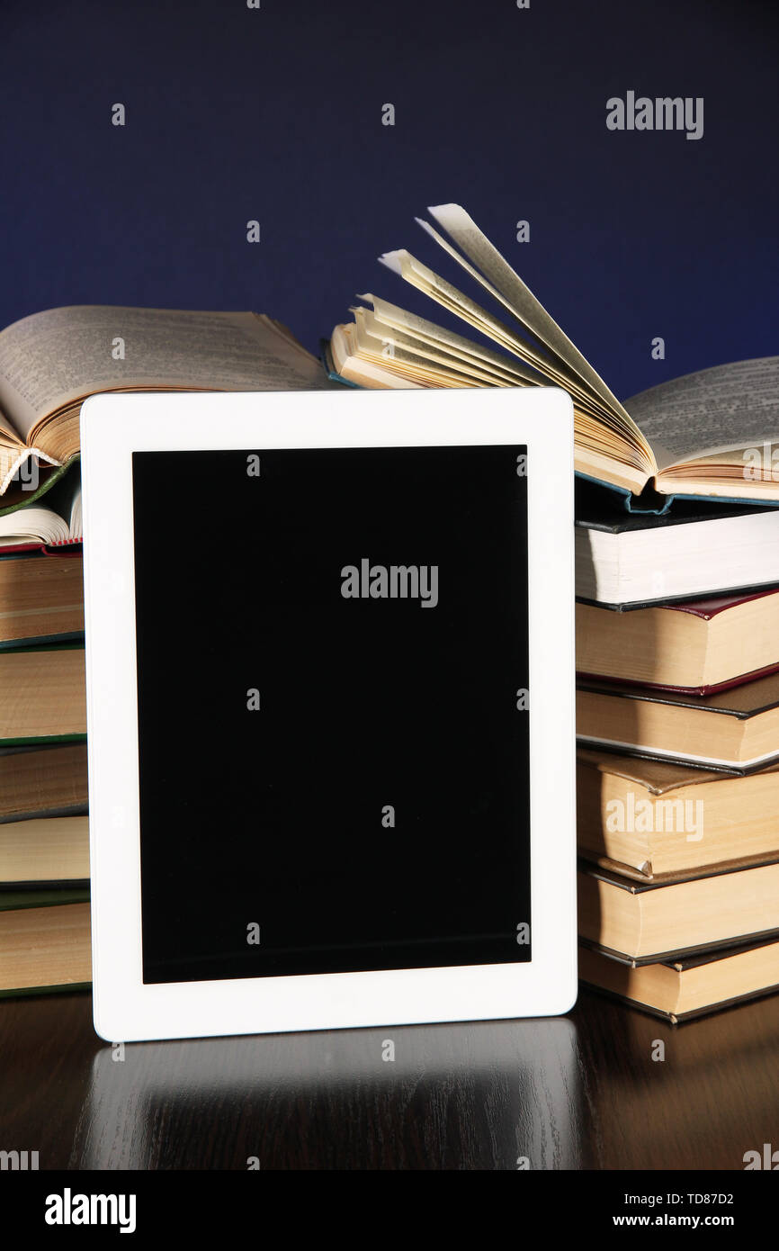 Tablet and books on bright background Stock Photo