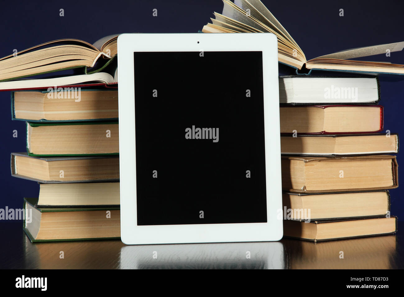 Tablet and books on bright background Stock Photo