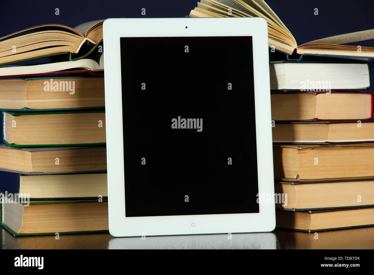 Tablet and books on bright background Stock Photo