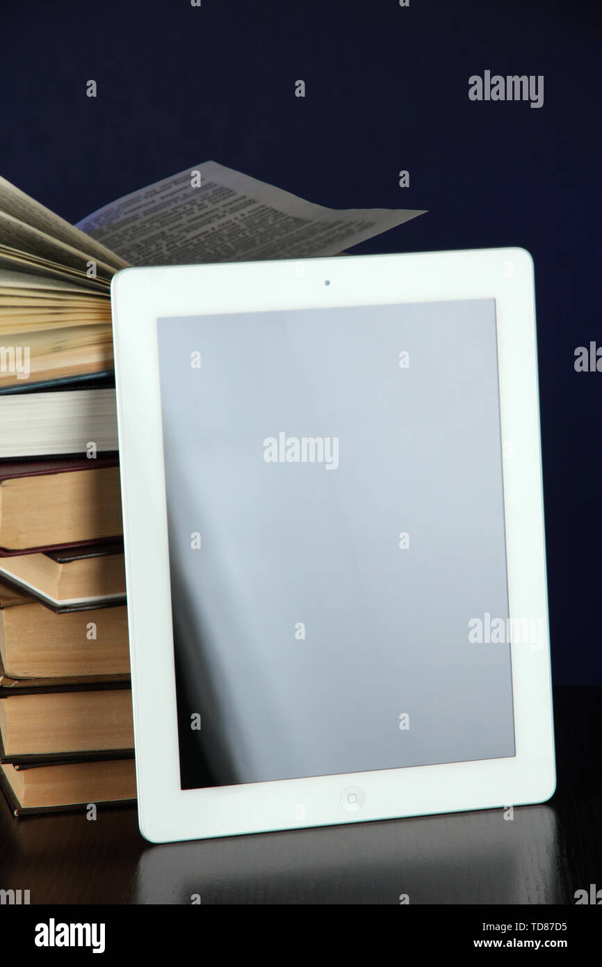 Tablet and books on bright background Stock Photo