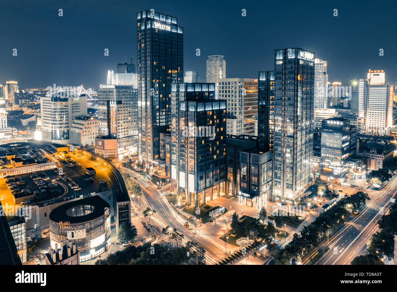 Illuminated westin hotel in ningbo and night view bridge hi-res stock ...