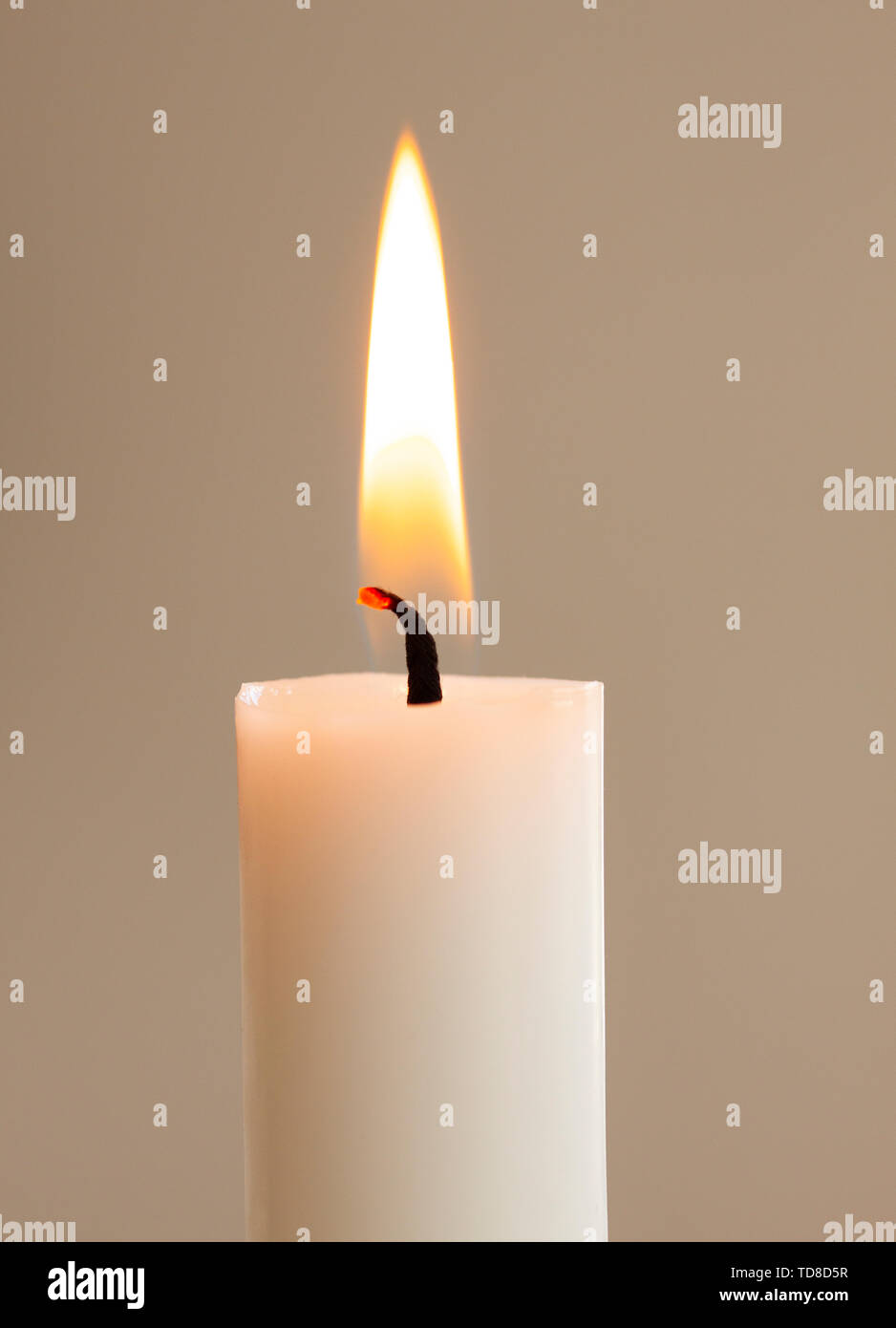 Burning candle light close up on white background Stock Photo - Alamy