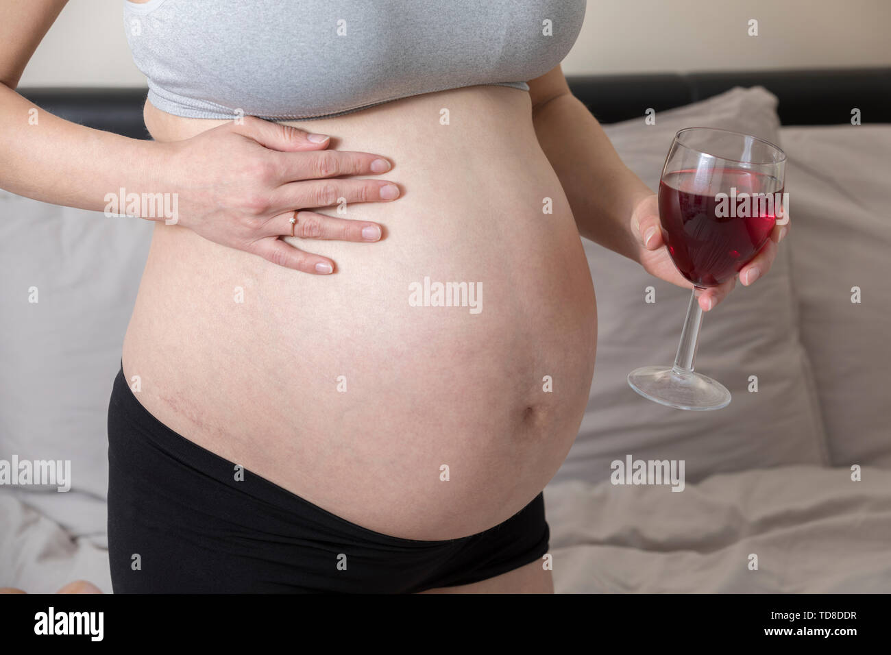 Pregnant Woman Drinking Alcohol, Girl in Pregnancy Holding Glass of Wine. Unhealthy life style. Pathology social issue Stock Photo