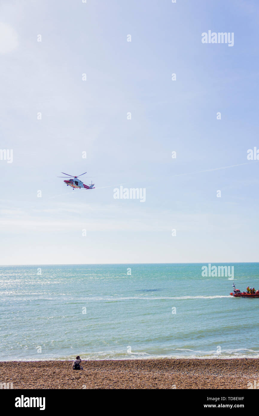 A view of a flying helicopter over the beach in Brighton, Sussex, UK Stock Photo