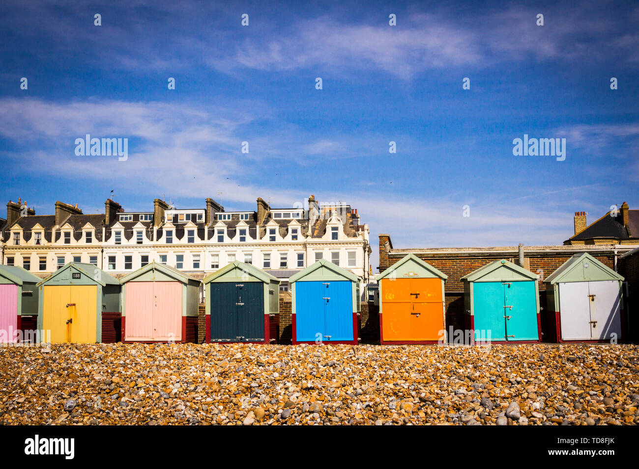 Landscape with row of colorful beach huts of Hove, Brighton, UK. Blue sky, clouds. Stock Photo