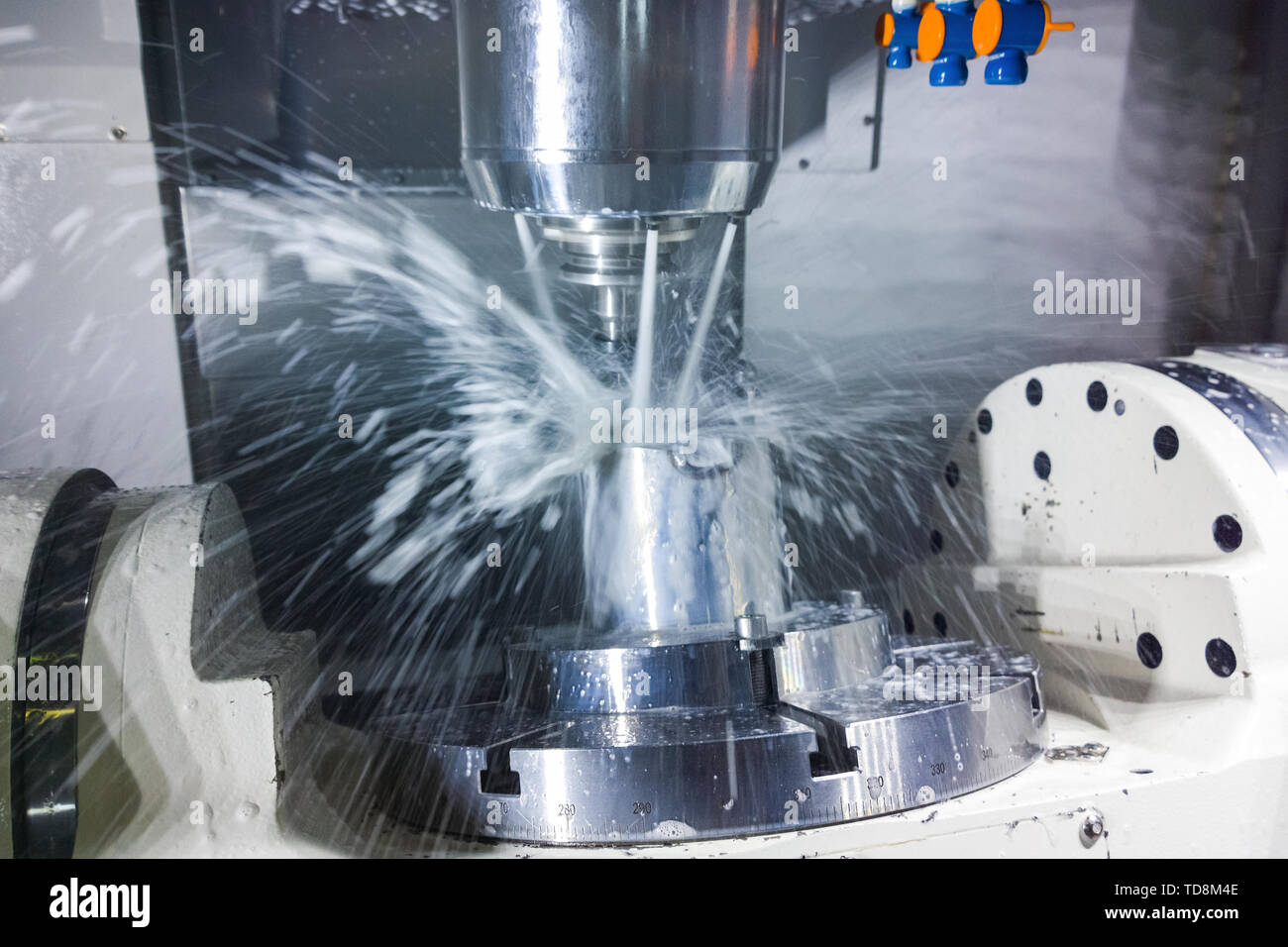 5axis cnc milling machine at work with coolant under pressure and