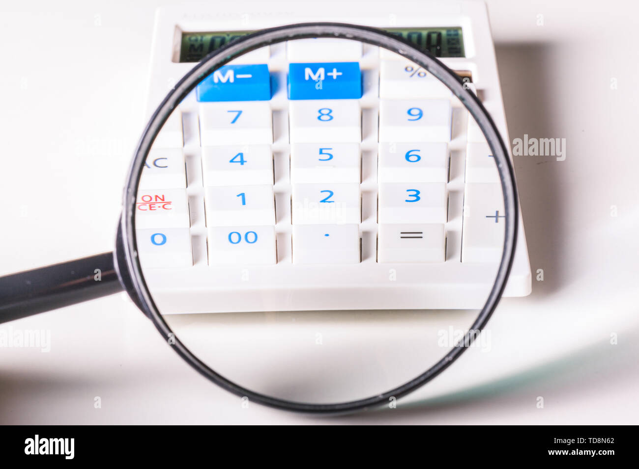 Magnifier and the calculator Stock Photo - Alamy