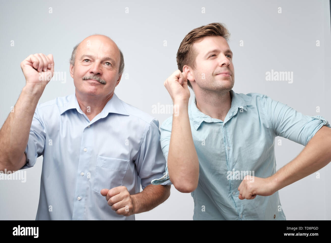 Two handsome male friends dancing on birthday party Stock Photo