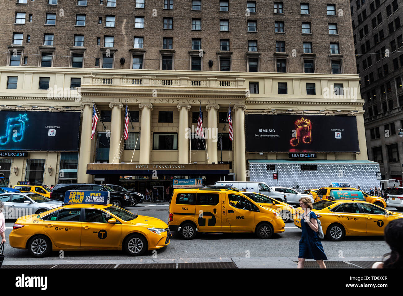 New York City, USA - July 31, 2018: Facade of the Pennsylvania Hotel, in front of the Madison Square Garden and Penn Station with traffic and people a Stock Photo