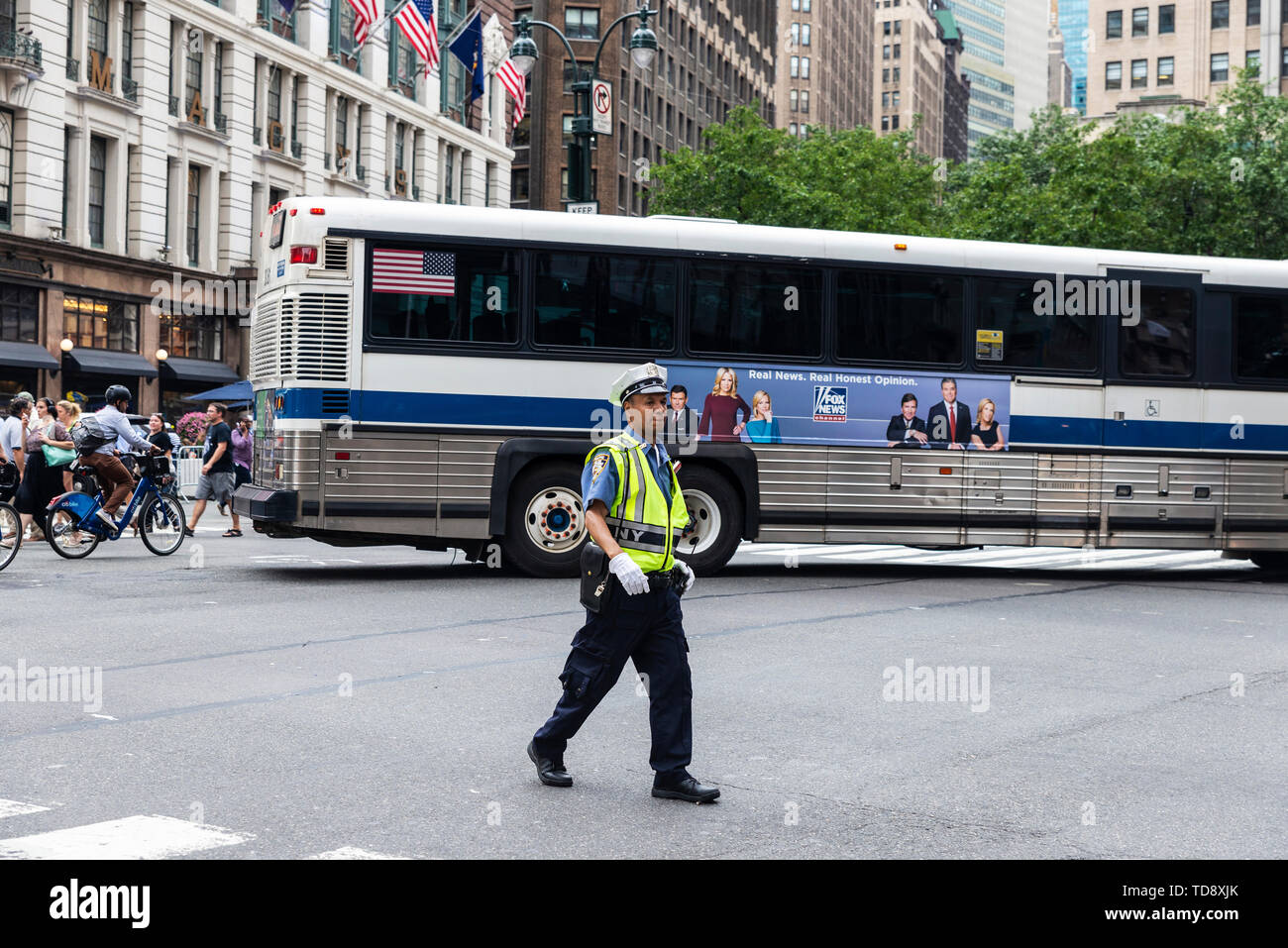 New York City, USA - July 31, 2018: Police directing the traffic with people around in Manhattan, New York City, USA Stock Photo