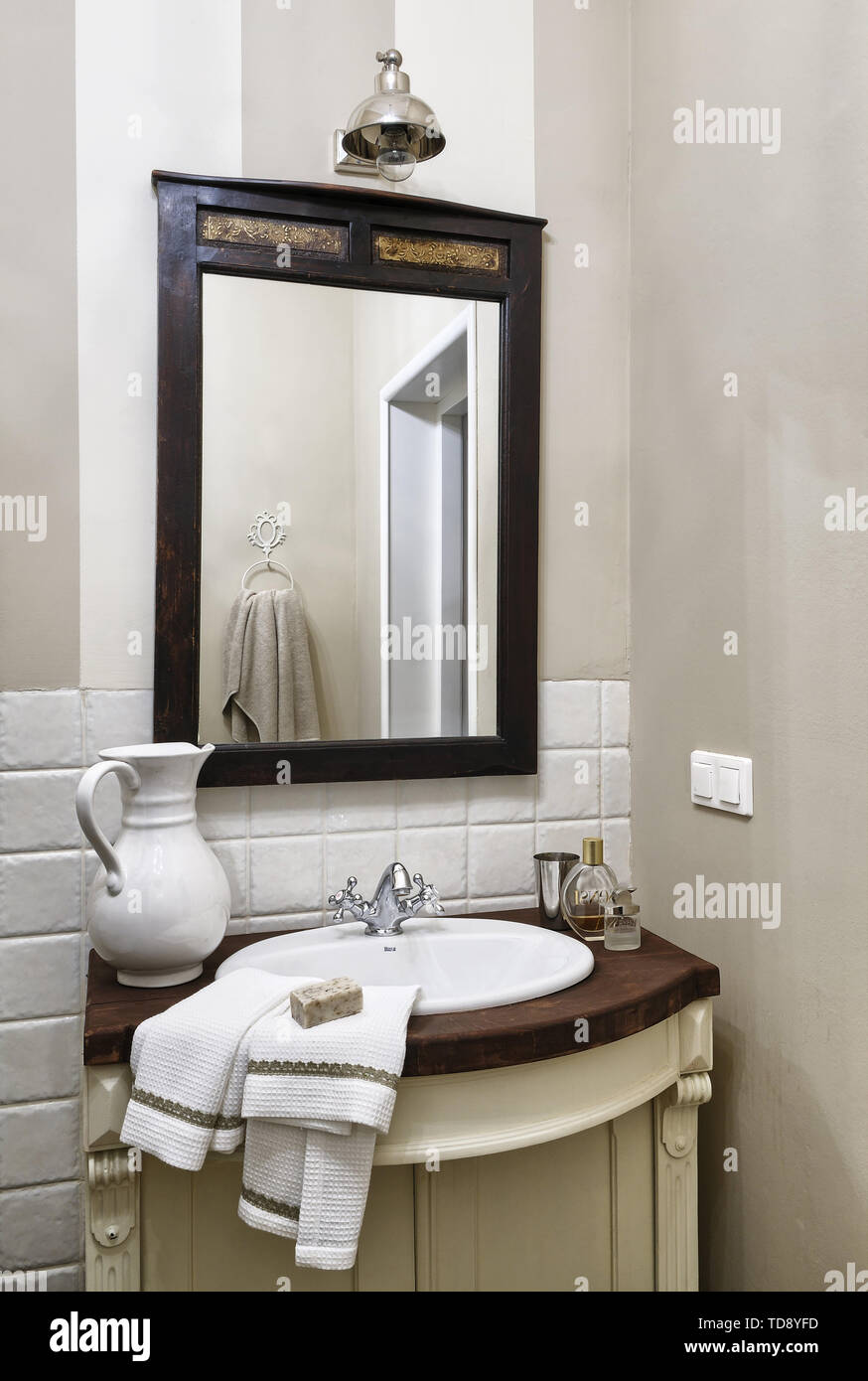 Mirror above wash basin in stand in corner of traditional bathroom   UK & IRISH USE ONLY Stock Photo