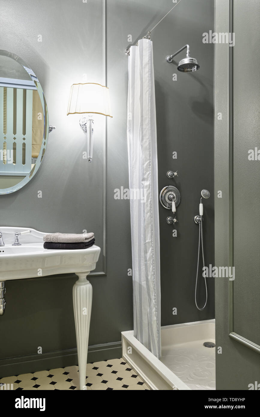 Free-standing white washbasin next to shower in classic style bathroom   UK & IRISH USE ONLY Stock Photo