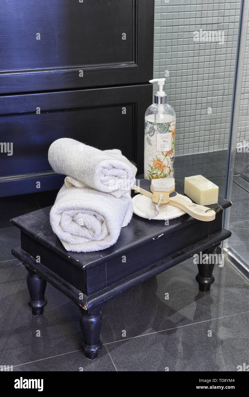 Towels and soap on wooden stool in bathroom   UK & IRISH USE ONLY Stock Photo