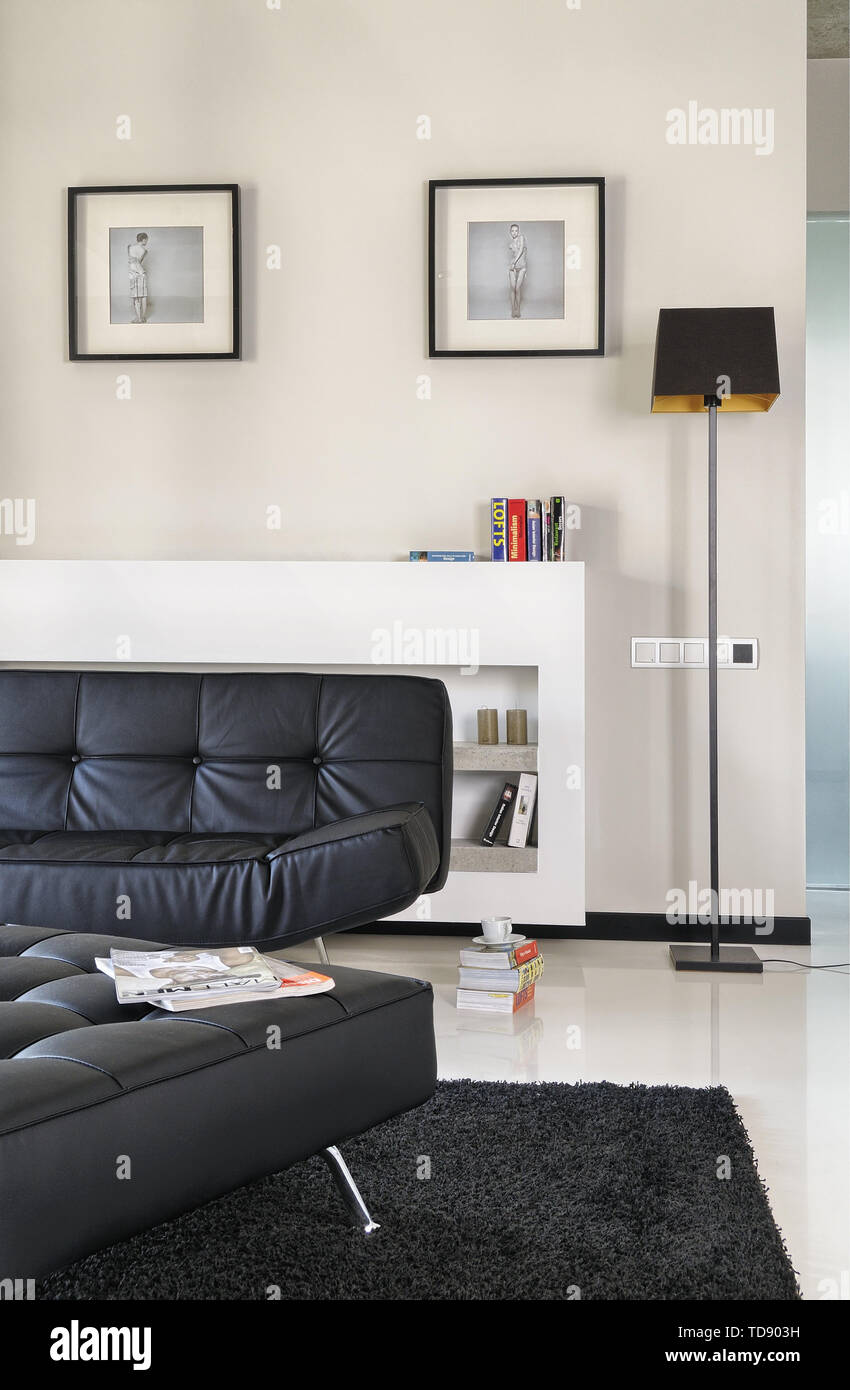 Leather ottoman and sofa in front of concrete shelves built-in radiator  cover in modern living room UK AND IRISH RIGHTS ONLY Stock Photo - Alamy