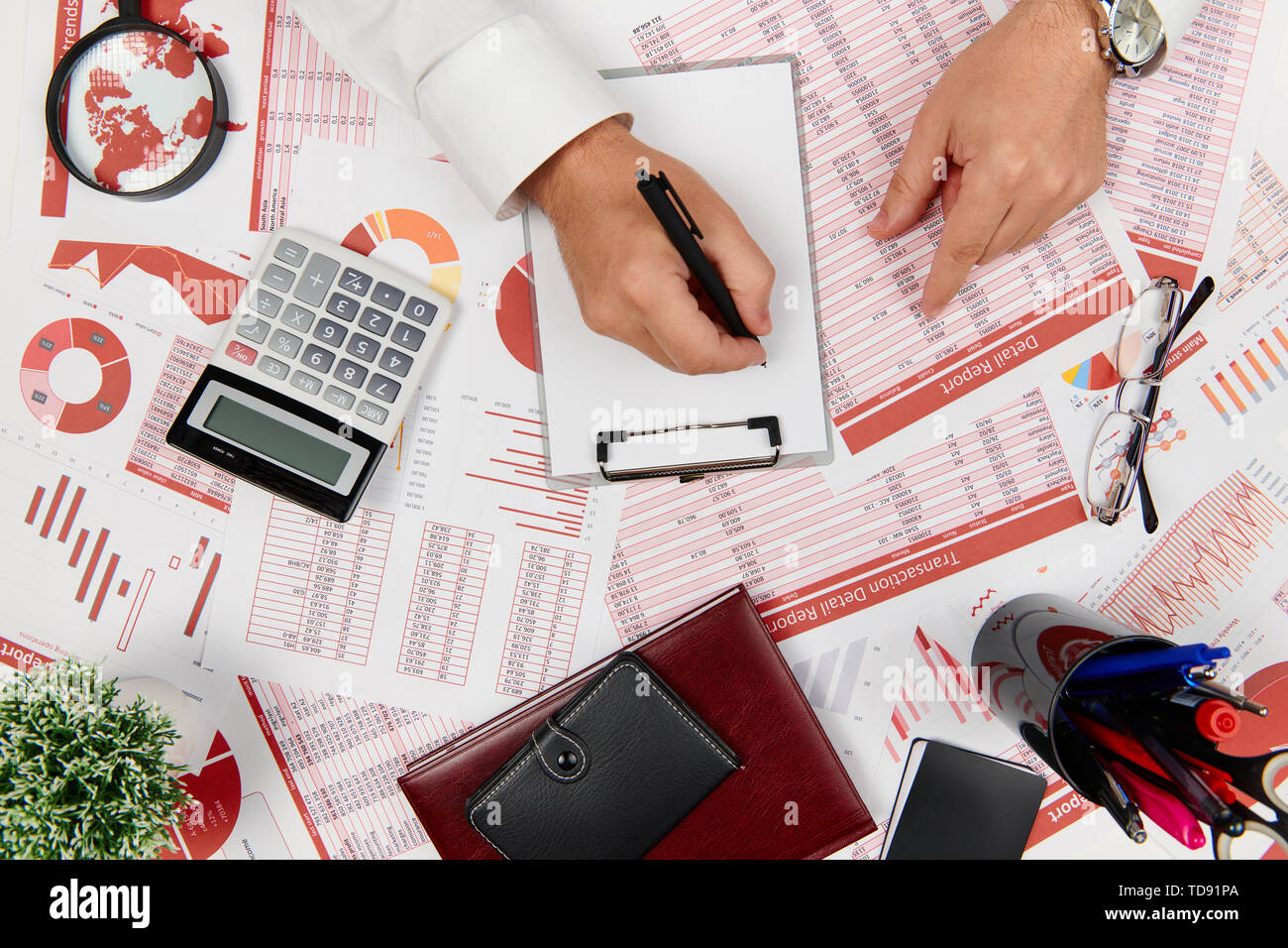 Flat top view of businessman working and calculating finance, reads and ...