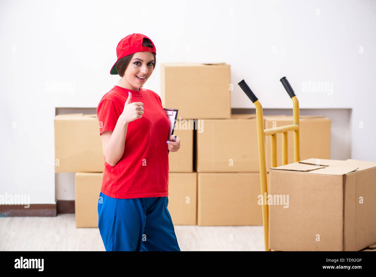 Young female professional mover doing home relocation Stock Photo