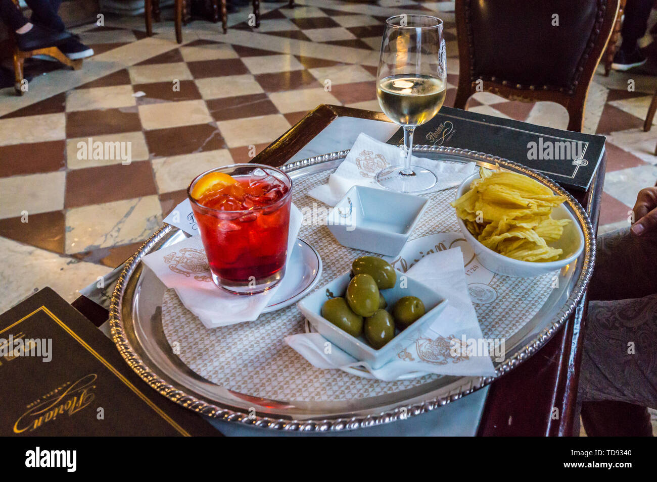 Aperol spritz and white wine with snacks at Caffè Florian, St. Mark's Square, San Marco, Venice, Veneto, Italy Stock Photo