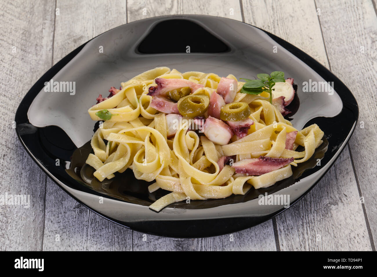 Pasta with octopus and olives Stock Photo - Alamy