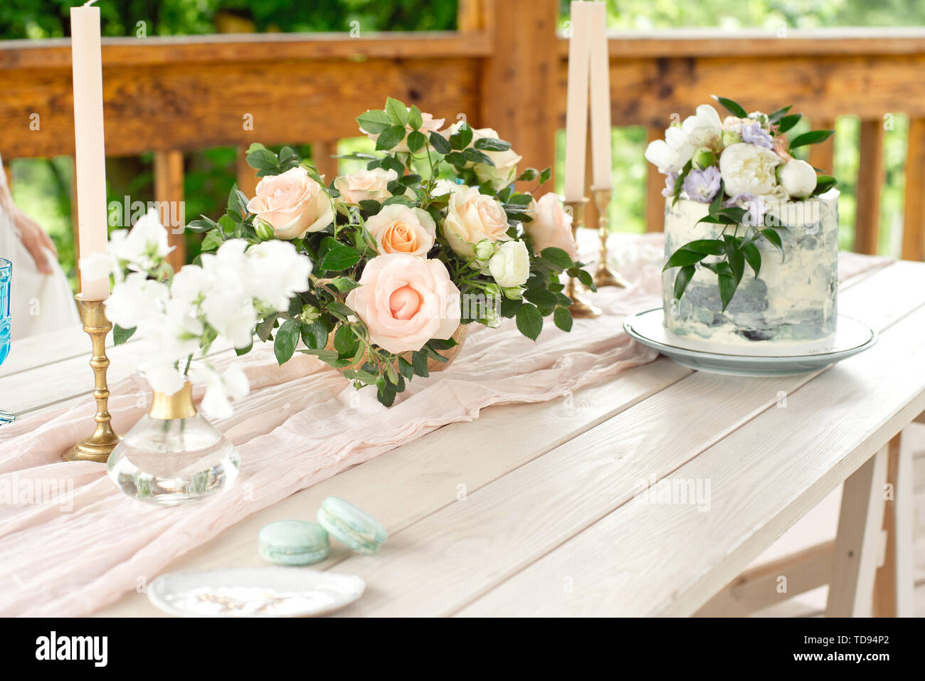 Wedding decoration table in the garden, floral arrangement, candles In the  style vintage on outdoor. Wedding cake with flowers. Decorated table with f  Stock Photo - Alamy