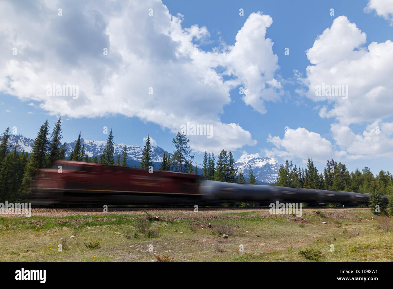 Fast moving train with mountainous landscape background Stock Photo