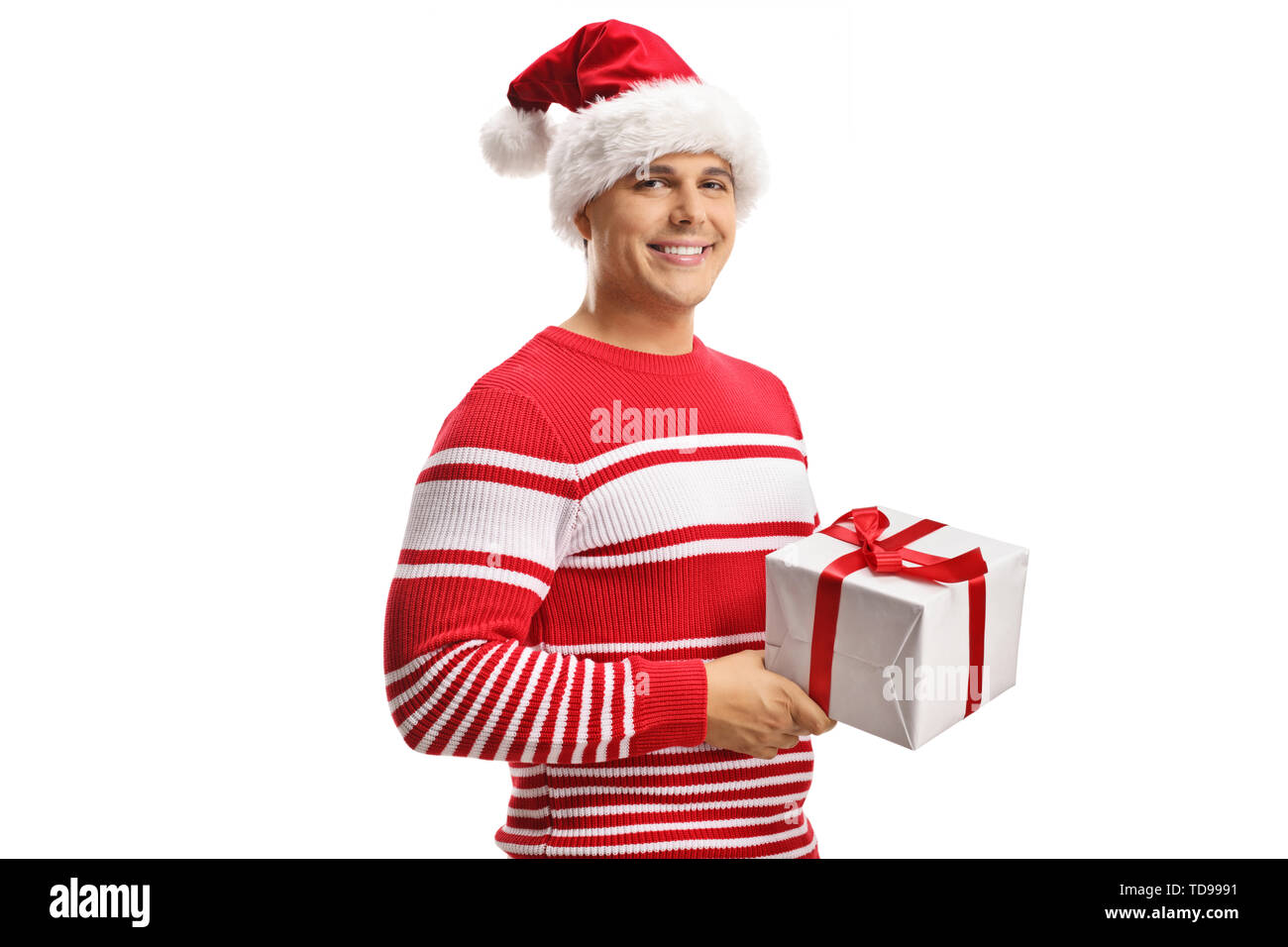 Young man wearing a santa claus hat and holding a christmas gift box ...