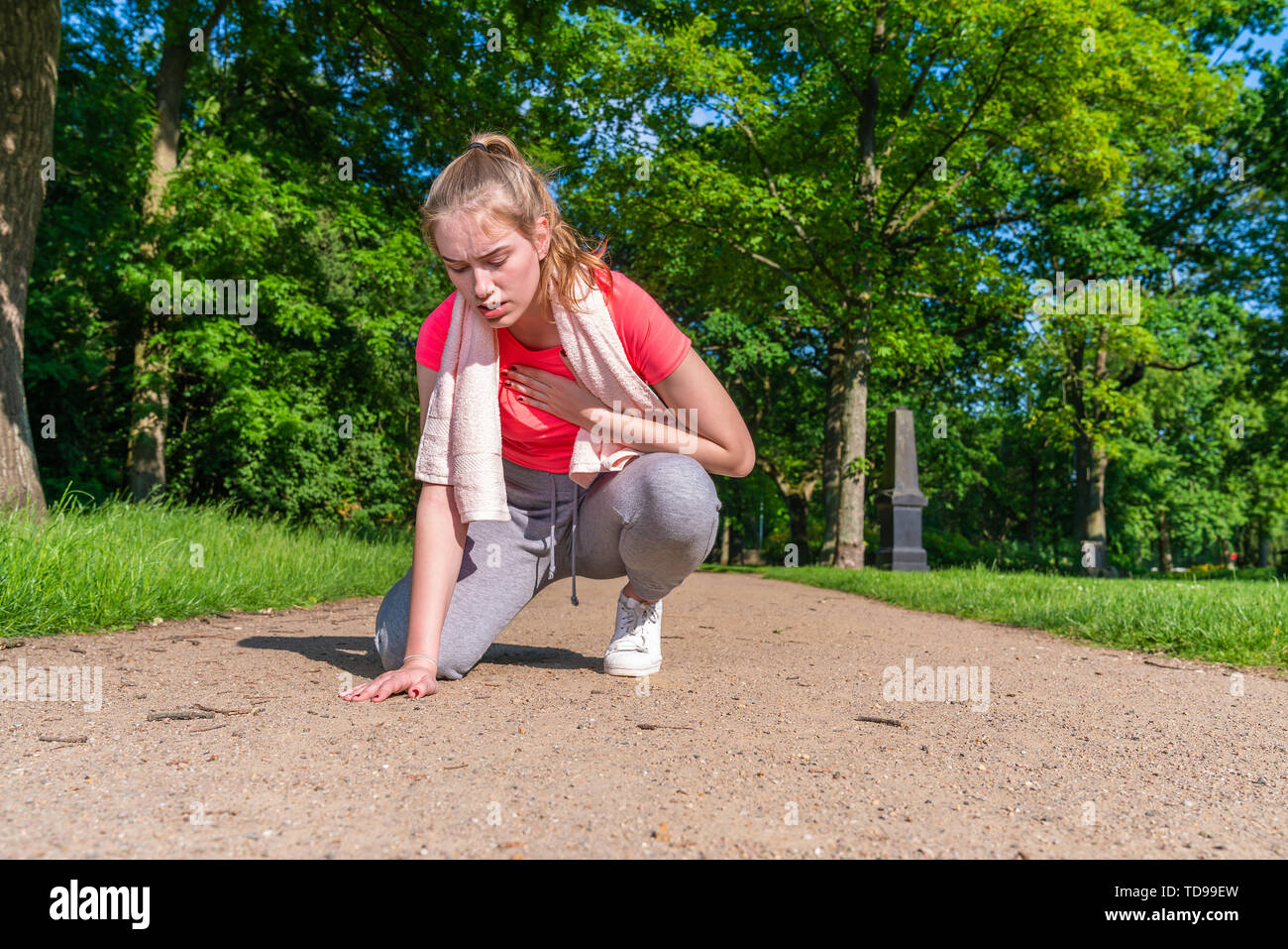 Young woman has circulatory problems during sports Stock Photo