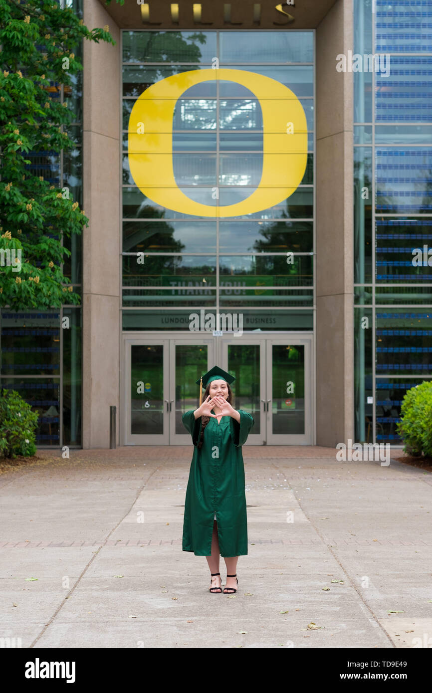 Eugene, OR - May 19, 2019: University of Oregon graduate Lacie Brown celebrates her graduation in cap and gown on campus in Eugene. Stock Photo