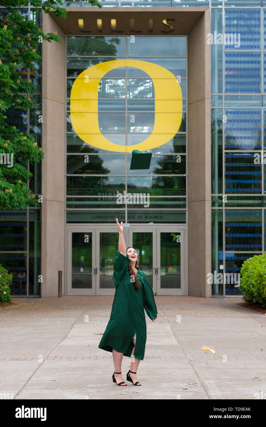 Eugene, OR - May 19, 2019: University of Oregon graduate Lacie Brown celebrates her graduation in cap and gown on campus in Eugene. Stock Photo