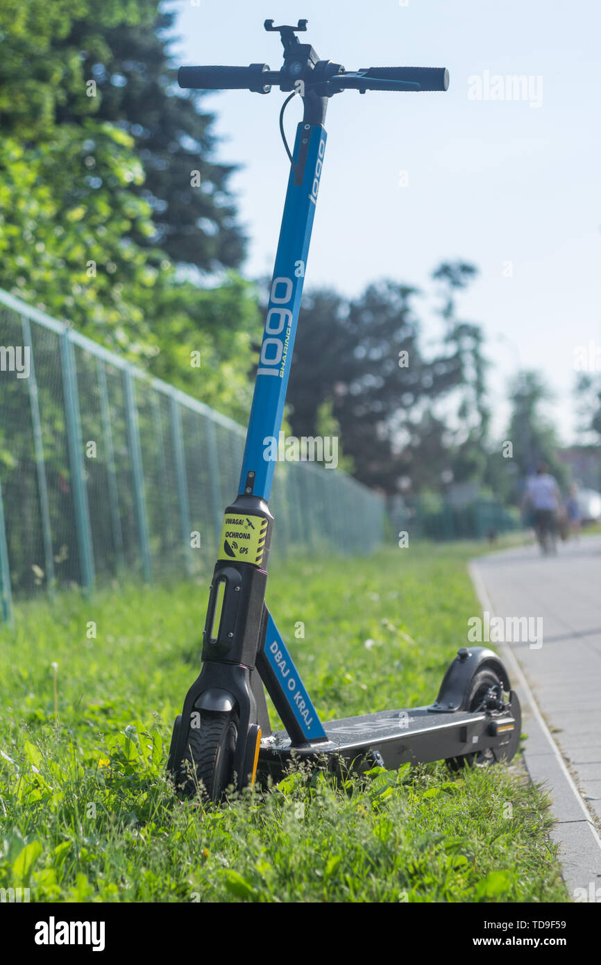 Gdansk, Poland - June 6, 2019: Blue electric scooter standing on green  grass next to the sidewalk and waiting for the customer Stock Photo - Alamy