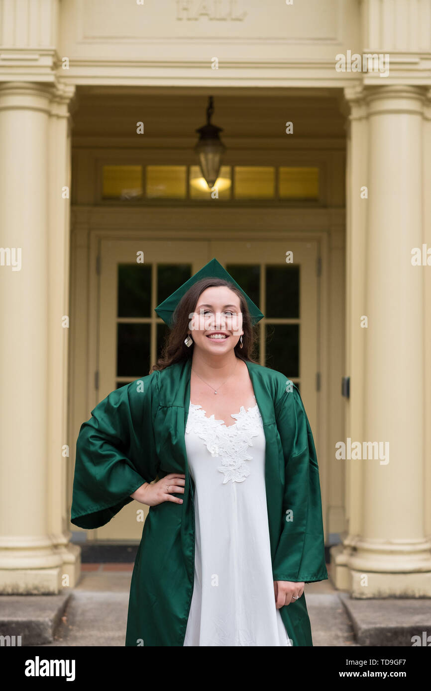 Graduate Def University graduate on her college campus in a cap and gown celebrating ...