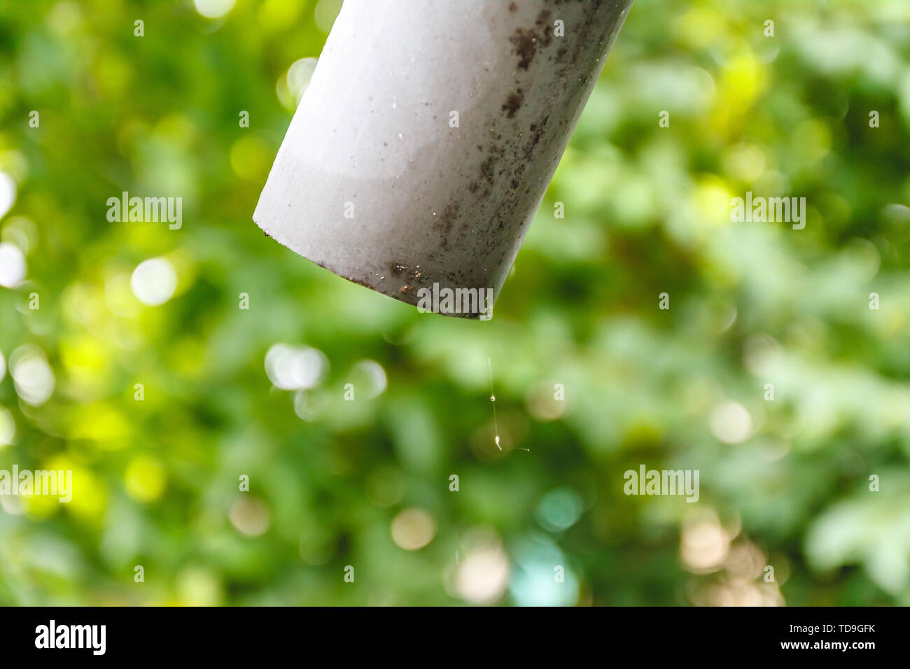 Water is dripping from an old pipe on a house outside Stock Photo Alamy