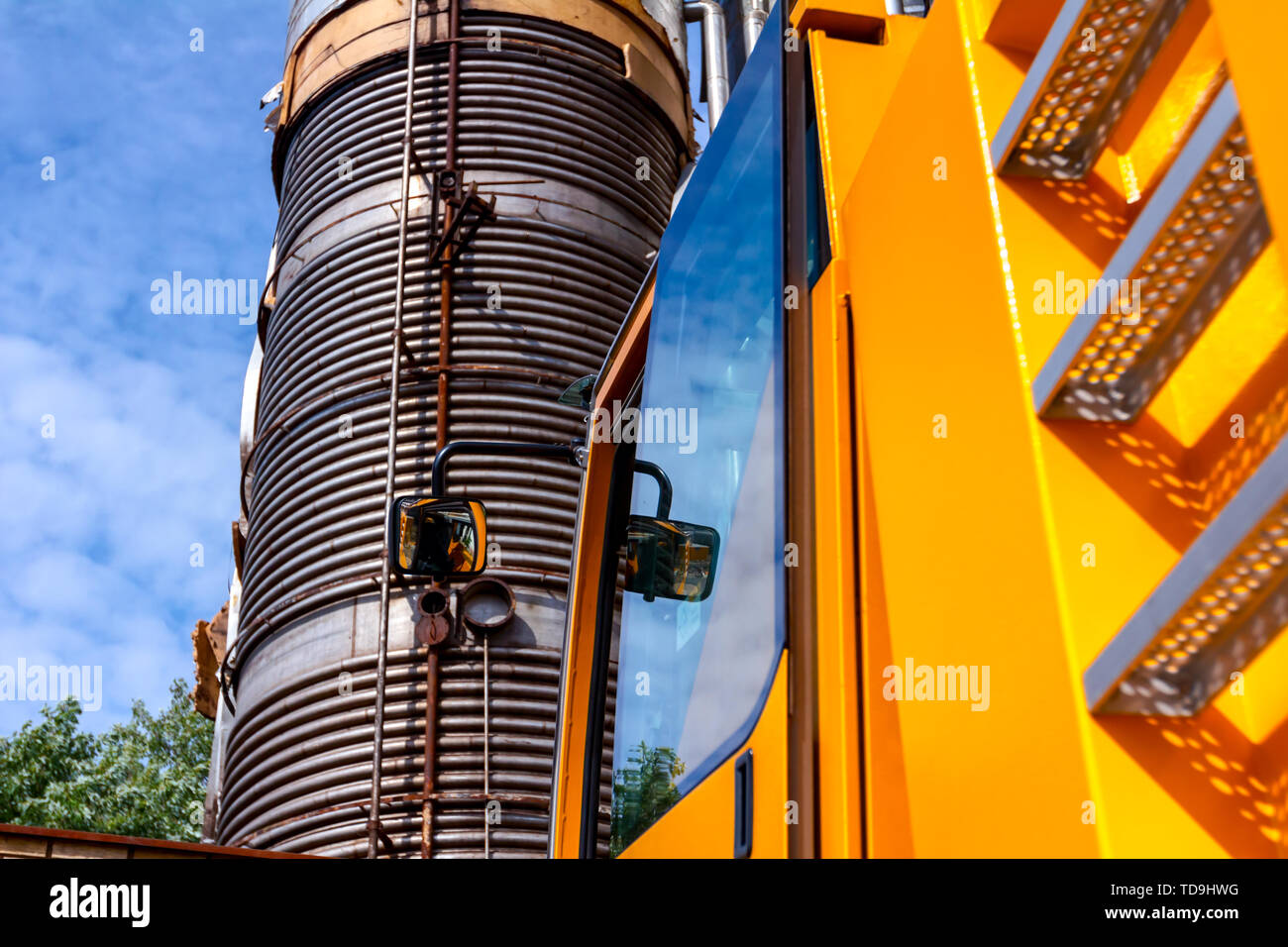 Metal ladders behind cabin on mobile crane with hook and straps is