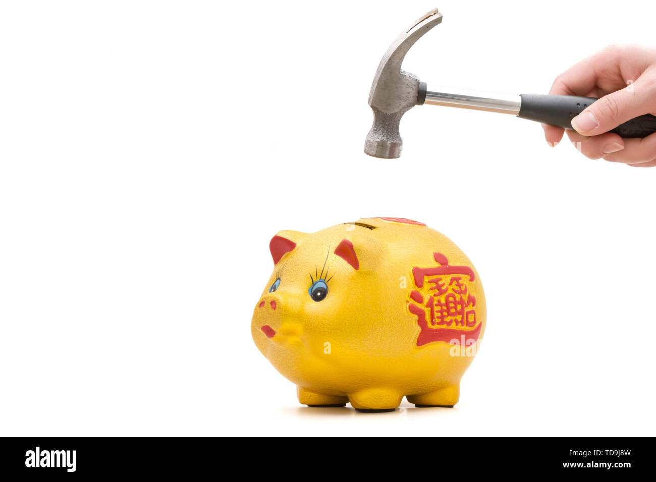 An old-fashioned hammer is about to hit a gold piggy bank Stock Photo ...