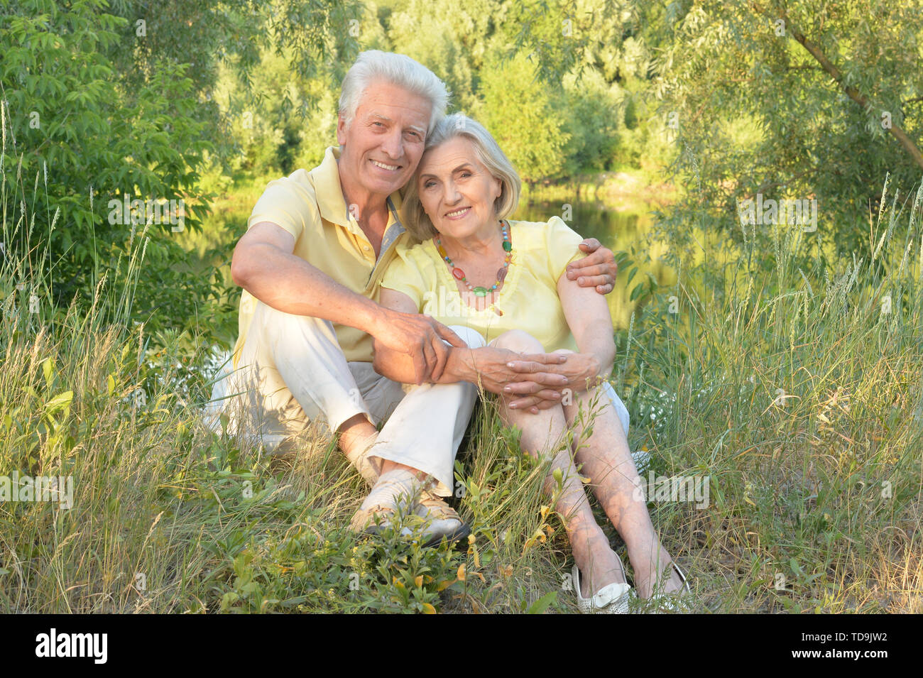 Portrait of beautiful senior couple relaxing and posing in the summer ...
