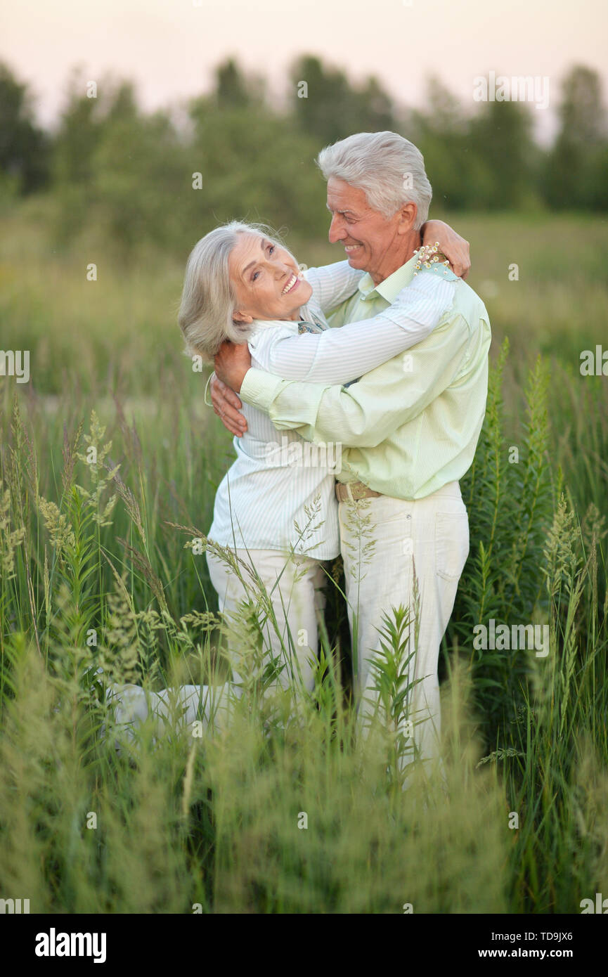 Portrait of beautiful senior couple relaxing and posing in the summer ...