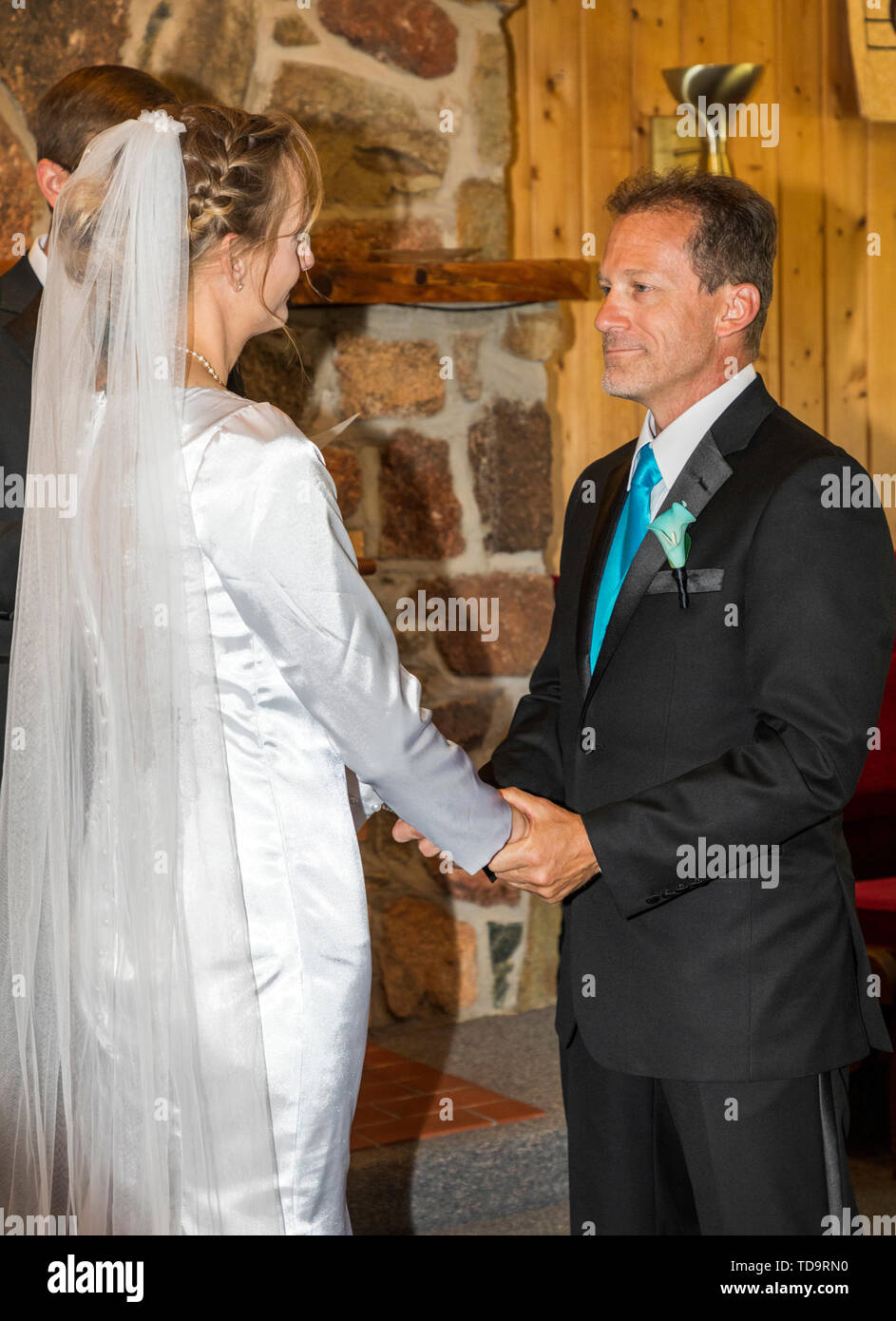 Bride & groom exhange wedding vows; wedding ceremony; Congressional Church; Buena Vista; Colorado; USA Stock Photo