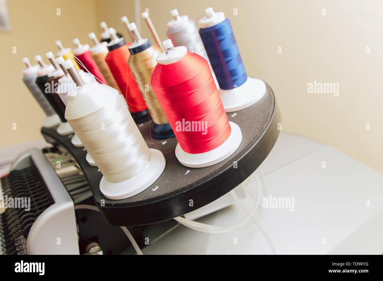 colored thread on the sewing machine. industrial embossing text on