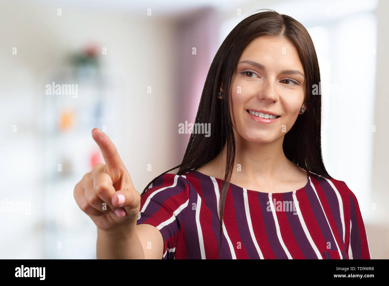 Happy smiling beautiful young woman showing copyspace Stock Photo - Alamy