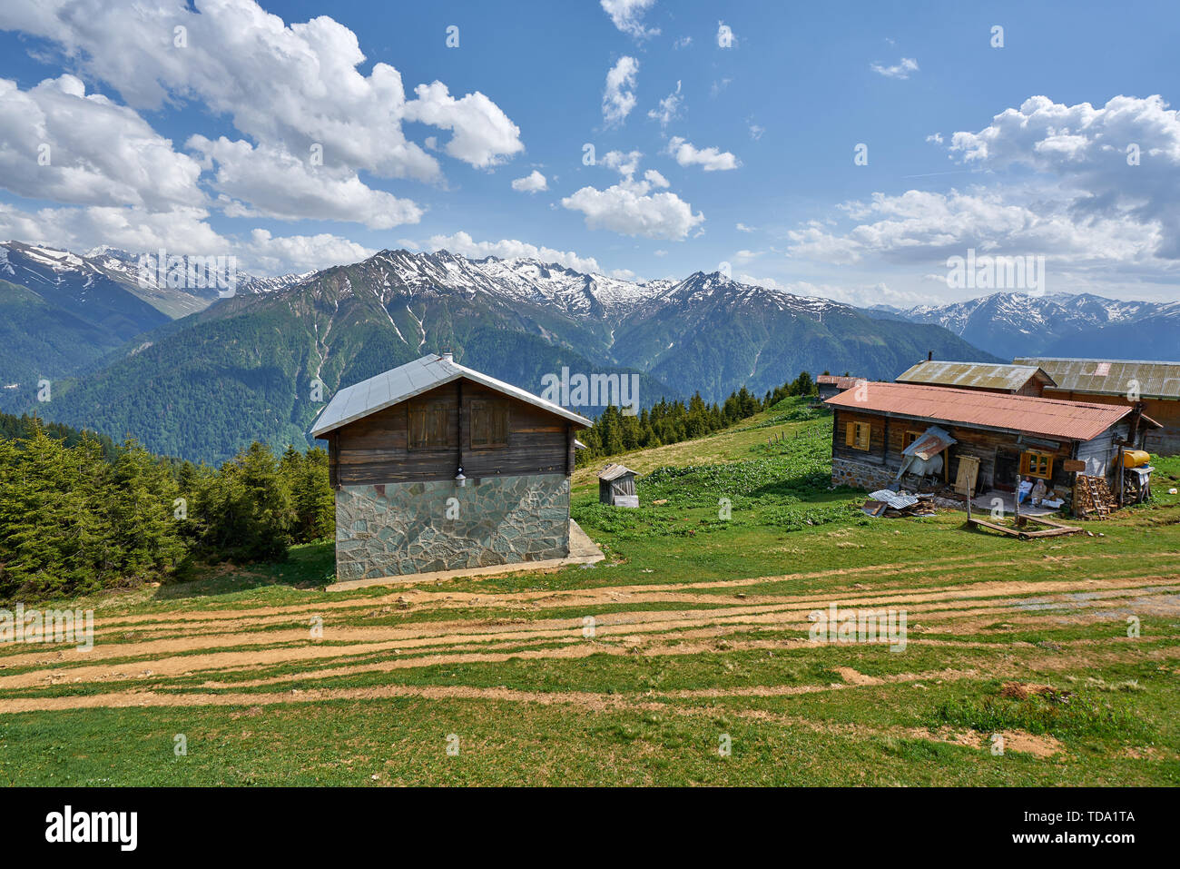 Green Nature Snowy Mountains And Traditional Wooden Plateau Houses Green Nature Snowy Mountains And Traditional Wooden Plateau Houses