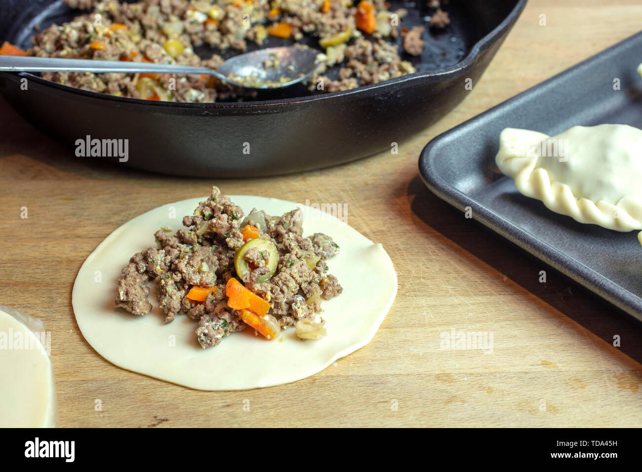 Preparation of Argentine empanadas with a ground beef, olives, carrouts