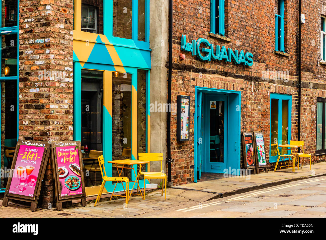 The colourful front entrance of a Las Iguanas restaurant, a chain specialising in Latin American dining, in the city of York, UK. August 2018. Stock Photo