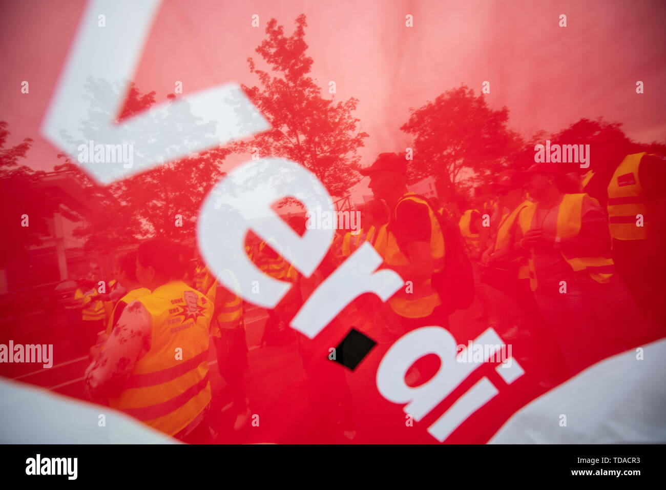 Neckarsulm, Germany. 14th June, 2019. Striking Kaufland employees stand in front of the group's headquarters in Neckarsulm. After the fruitless negotiations in the collective bargaining round for the retail sector, the Verdi trade union is calling for warning strikes at the Kaufland supermarket chain on Friday. Credit: Fabian Sommer/dpa/Alamy Live News Stock Photo