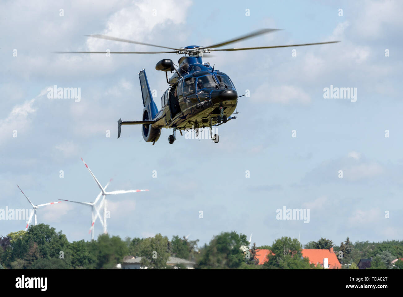 13 June 2019, Saxony, Nünchritz: An EC 155 b1 helicopter lands on a field during a helicopter-assisted water rescue exercise from the Elbe. The Bundespolizei-Fliegerstaffel Blumberg, together with the Wasserwacht Sachsen and the Deutsche Lebens-Rettungs-Gesellschaft e.V. (German Life and Rescue Society), leads the (DLRG) is conducting a joint exercise to rescue people from flowing waters. Photo: Robert Michael/dpa-Zentralbild/ZB Stock Photo
