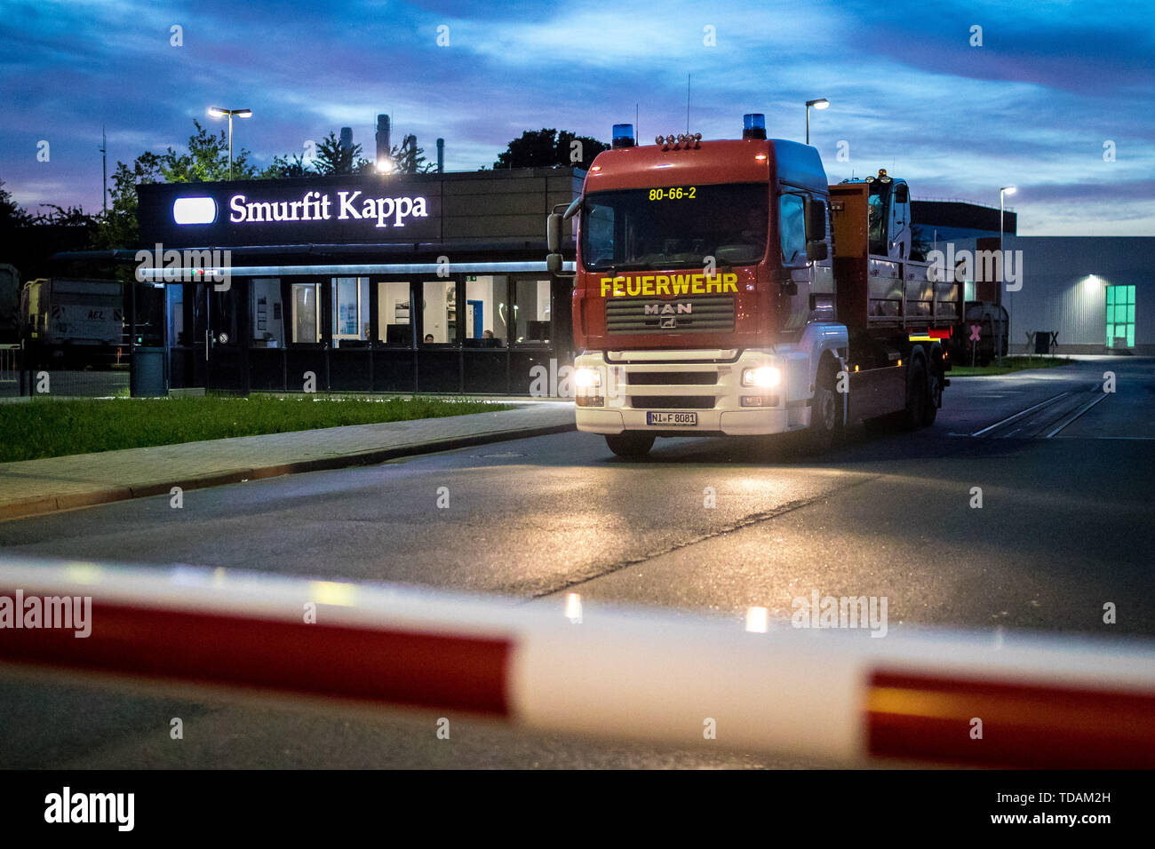 Hoya, Germany. 14th June, 2019. An emergency vehicle of the fire brigade  leaves the premises of Smurfit Kappa. A fire broke out in the paper and  cardboard factory in the district of