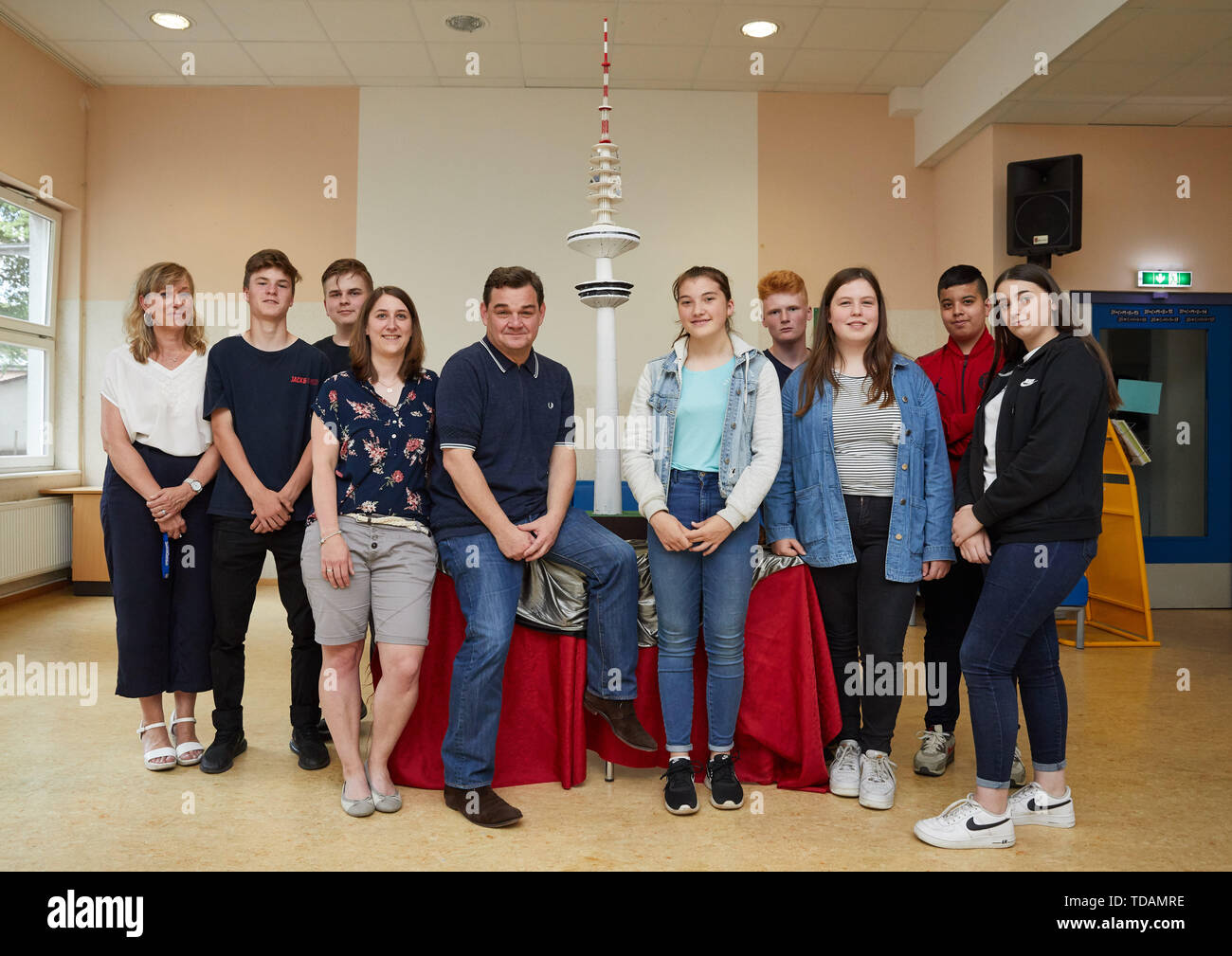 14 June 2019, Hamburg: Jeannette Engelhardt (l), and Daniela Prust (4th from left), teachers, Marcus Weinberg (5th from left, CDU), member of the Bundestag and former teacher of the Bonifatiusschule, as well as the students of profile class 8 of the Katholische Bonifatiusschule Wilhelmsburg, Benjamin (l-r), Shane, Jolyna, Norman, Paula, Nehad and Joanna present a two meter high model of the Tele-Michel. With this campaign, the students want to support the foundation Fernsehturm, which is committed to the reopening of the Hamburg television tower. Photo: Georg Wendt/dpa Stock Photo
