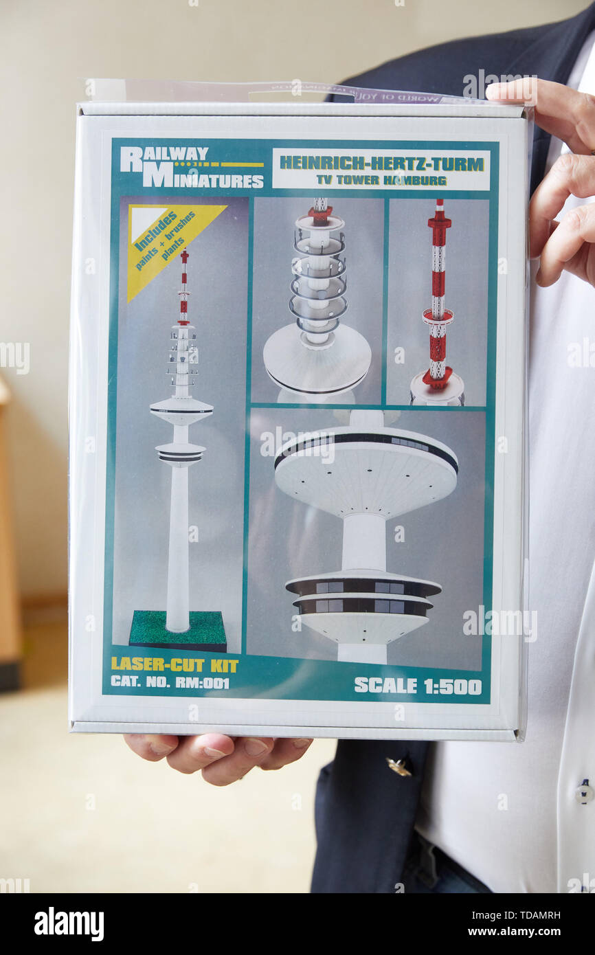 Hamburg, Germany. 14th June, 2019. Hartmut Witte, Marketing, Cooperation and Fundraising Foundation Fernsehturm, holds a model kit of the Heinrich Hertz Tower in his hands. Students of profile class 8 of the Catholic Bonifatius School Wilhelmsburg presented a two meter high model of the Tele-Michel that they had made themselves. With this campaign, the pupils support the Fernsehturm foundation, which is committed to the reopening of the Hamburg television tower. Credit: Georg Wendt/dpa/Alamy Live News Stock Photo